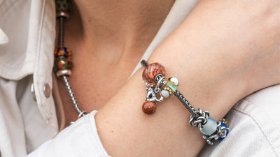Model wearing a necklace and a bracelet with Trollbeads beads 
